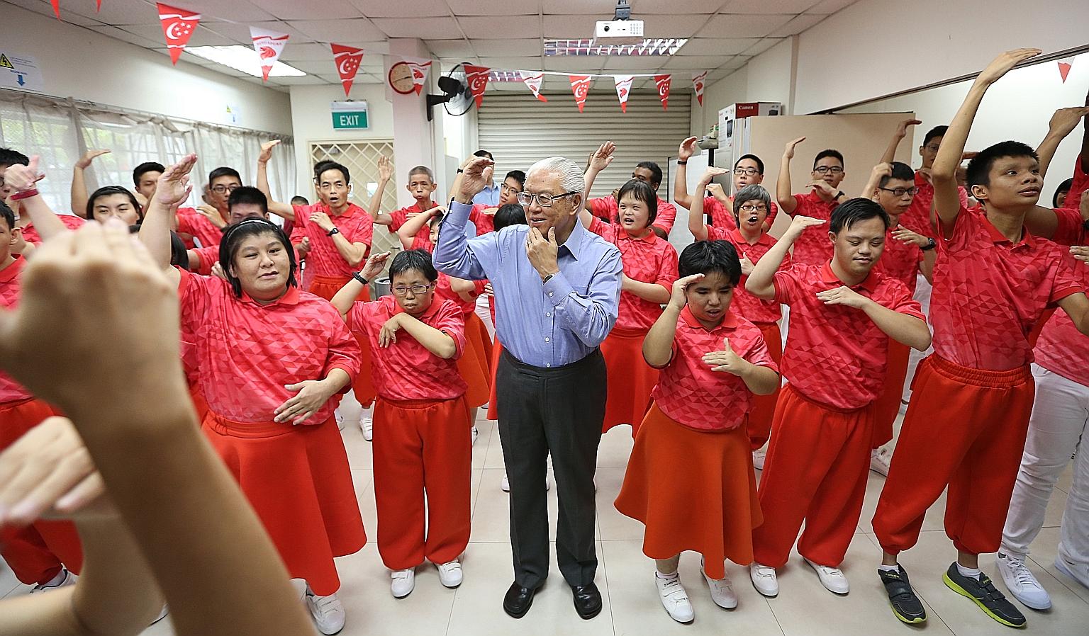 President Tony Tan at a song-signing rehearsal organised by Touch Community Services yesterday. The participants will lead the audience at the National Stadium in hand-signing to Home and Count On Me, Singapore.