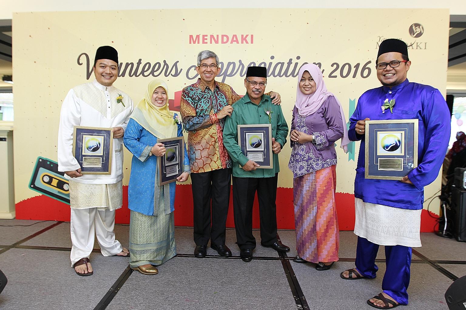Dr Yaacob (third from left) and Yayasan Mendaki CEO Tuminah Sapawi (fifth from left) with some of the award winners yesterday. They are (from left) Mr Muhammad (outstanding volunteer award), Madam Wahizah (long-service award), Haji Salim Suri (senior