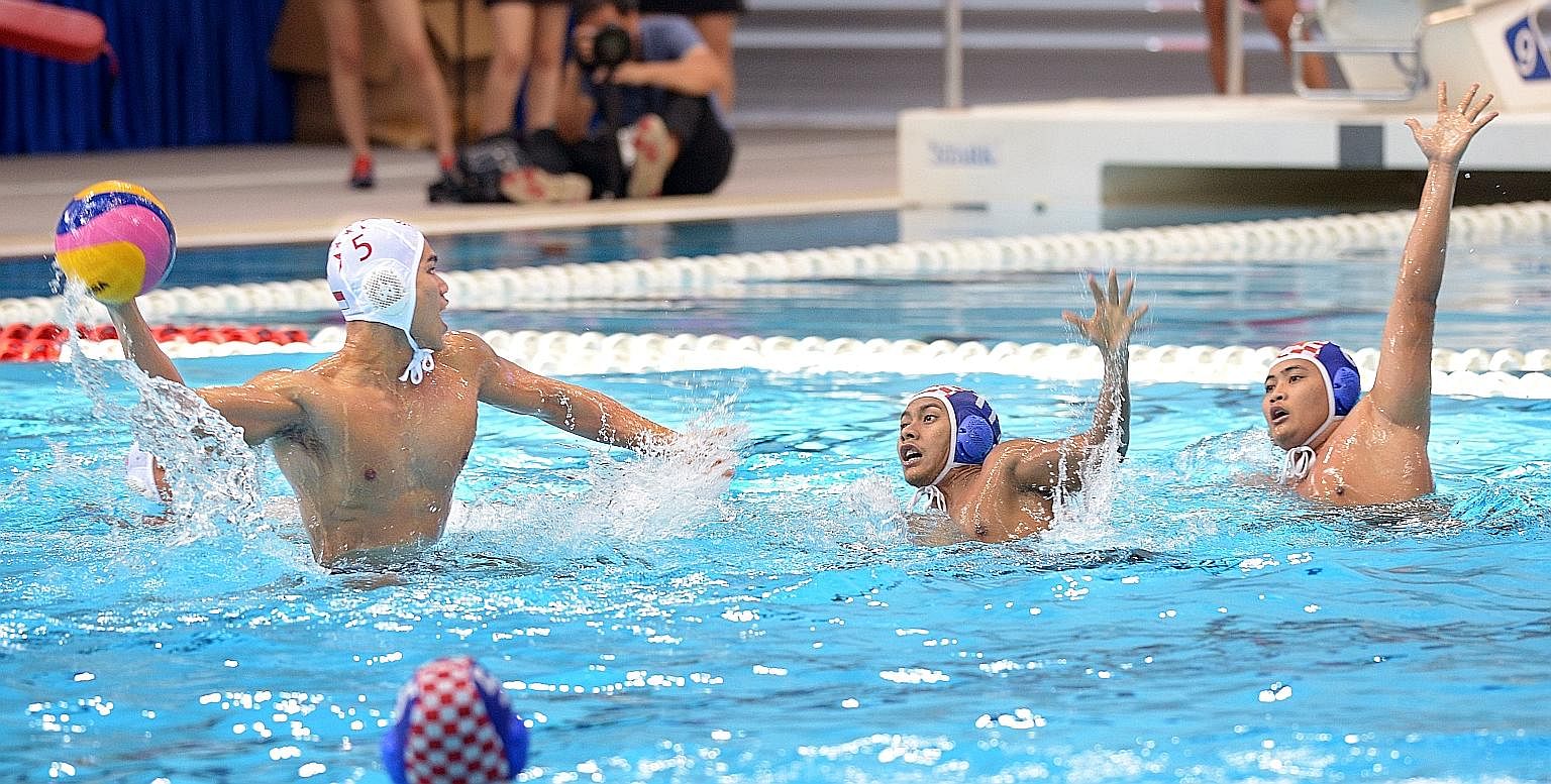 Ooi Yee Jia taking a shot as two Indonesian players attempt to block him in the final at the OCBC Aquatic Centre. Singapore edged out Indonesia 10-9 to win the AUG's final gold medal. Thailand thrashed the Philippines 17-7 for bronze.