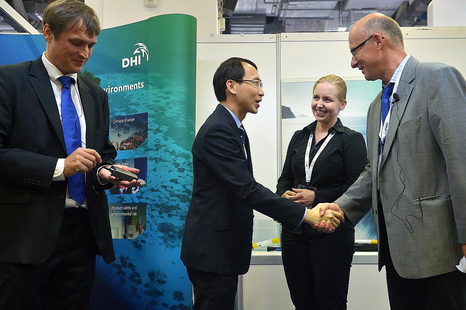 Mr Goh of the EDB greets Dr Ole Svenstrup Peterson, the incoming director of R&D at DHI Singapore. With them is Ms Groen, DHI's managing director. The Danish water and environmental firm is set to expand its R&D centre here.