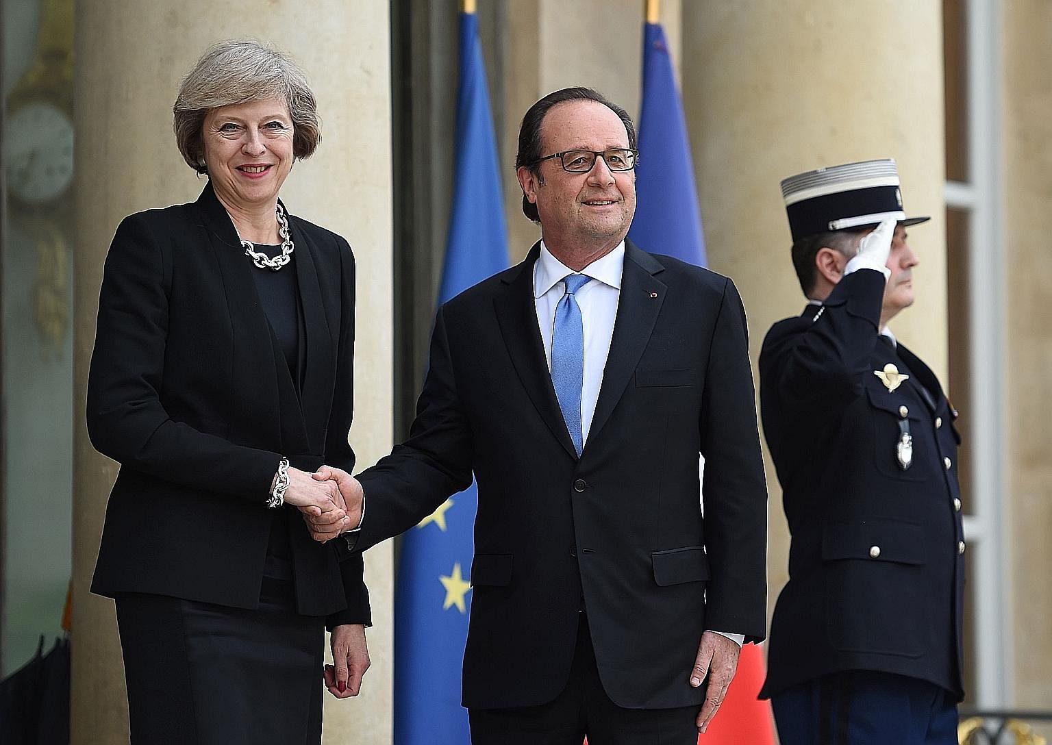 Mr Hollande welcoming Mrs May to the presidential Elysee Palace on Thursday.