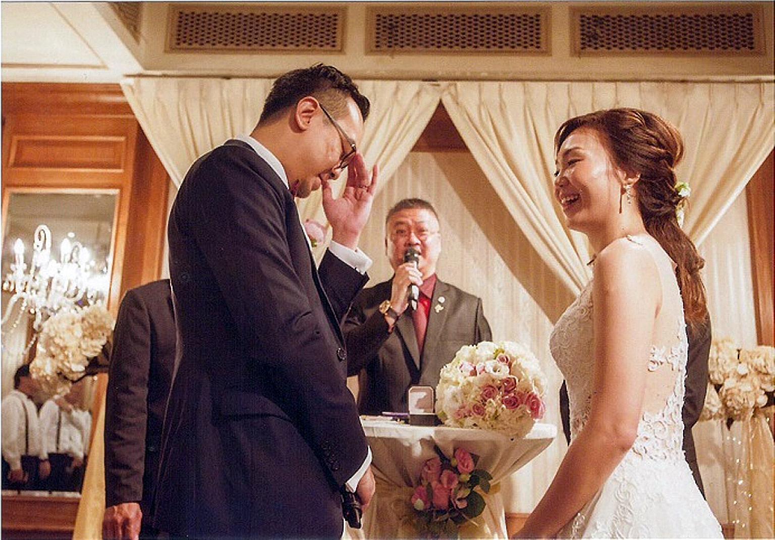 Mr Lim (centre) solemnising the marriage of Mr Jeremy Si, 32, and Ms Hazel Ng, 31, this year. The 49-year-old is one of nearly 200 grassroots leaders who, since 1992, have been authorised to solemnise marriages.