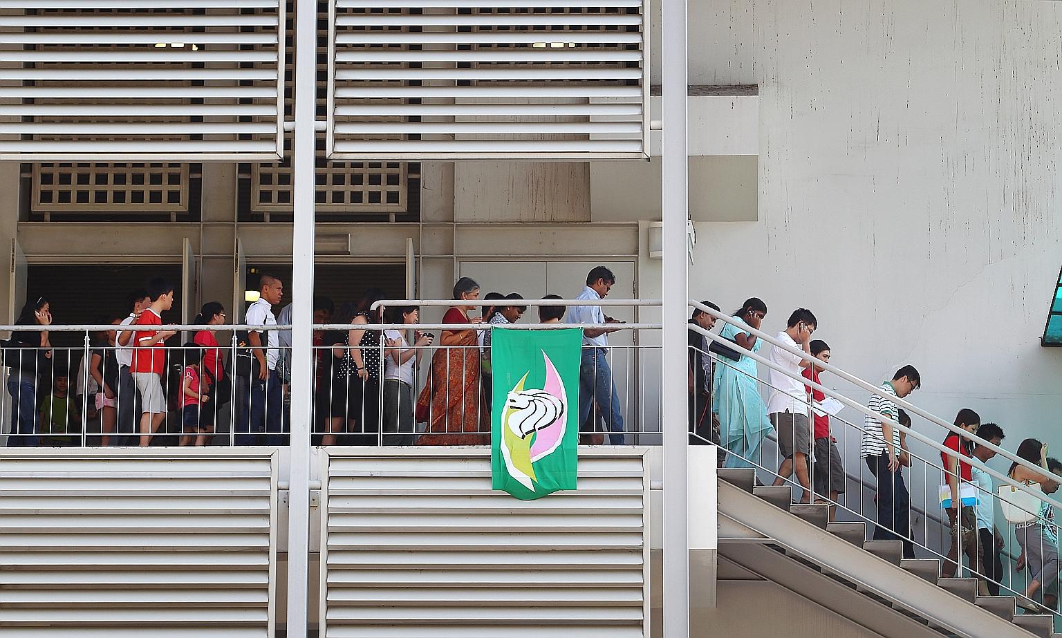 Parents leaving a school hall after a Primary 1 balloting exercise. The study, done by two Raffles Institution alumni last year, showed that better primary schools tend to be located in more affluent estates.