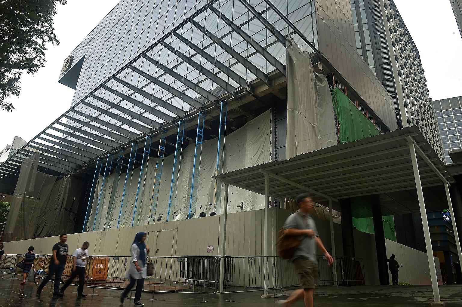 When The Straits Times visited the construction site at Knightsbridge mall (left) yesterday, the shop's interior was covered by construction canvas. However, tall glass structures were already in place, hinting at Apple's signature glass facade seen