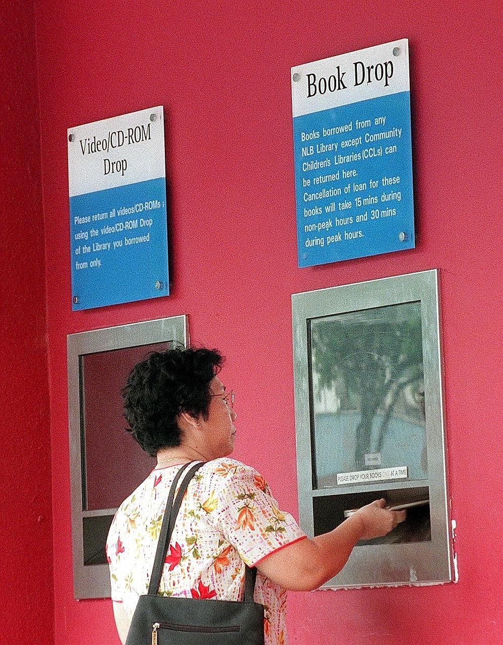 Library books being returned using a book drop. The National Library Board has other avenues to encourage prompt return of items, such as a free e-mail reminder service.