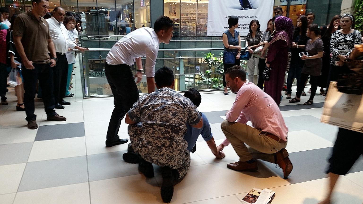 A 49-year-old man being held down by passers-by at Westgate after being spotted allegedly taking upskirt shots of a woman on an escalator at the neighbouring Jem mall.