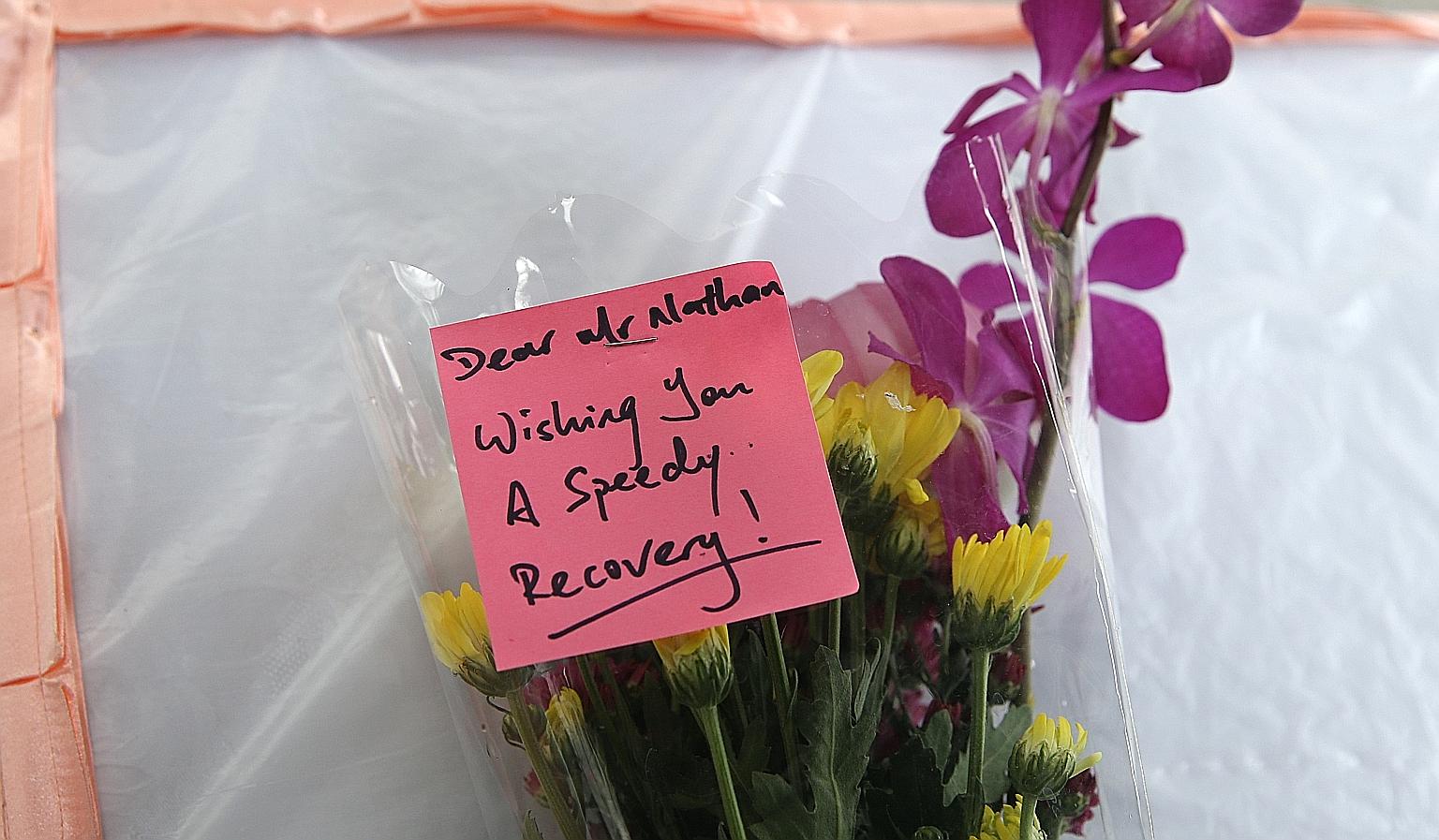 Visitors left flowers for Mr Nathan on a table outside SGH Block 5. He was hospitalised after a stroke on Sunday.