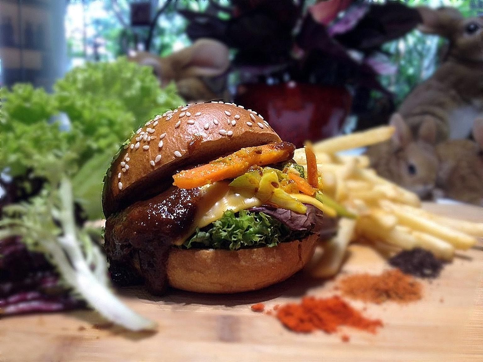 Beef cheek rendang burger with achar and Cajun fries (left) from Hareloom Cafe & Bar, run by chef Matthew Mok (above).