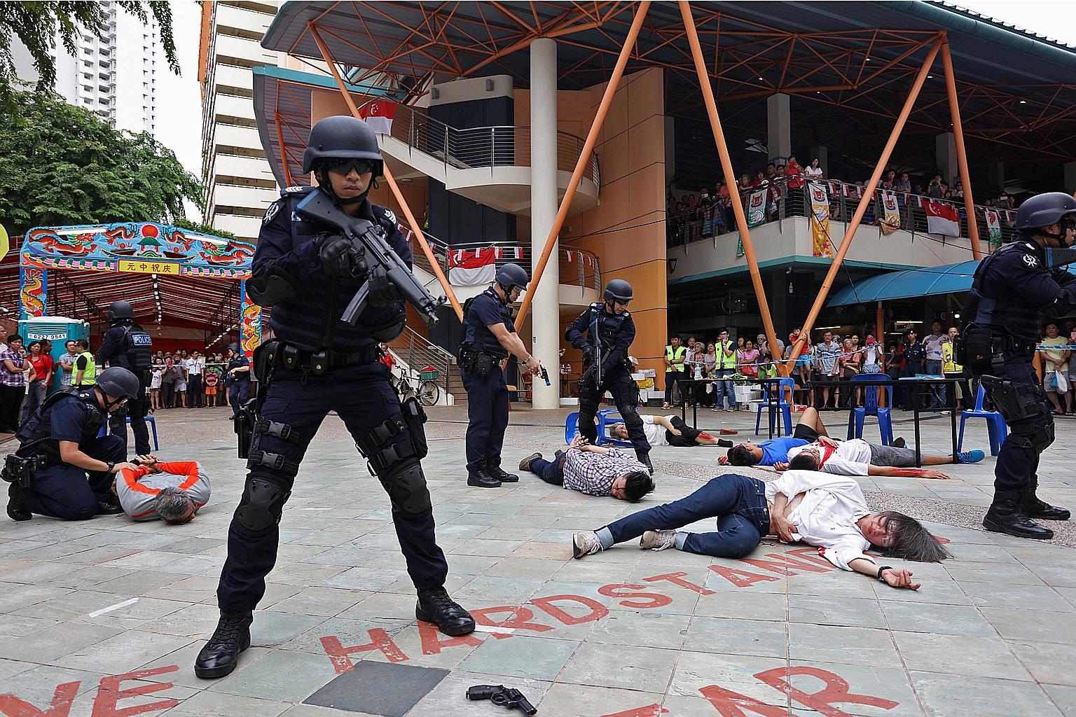 Officers from the Emergency Response Team, Tanglin Division and Ground Response Force from Toa Payoh Neighbourhood Police Centre securing a public space in Toa Payoh Lorong 1 during a counter- terrorism exercise yesterday.