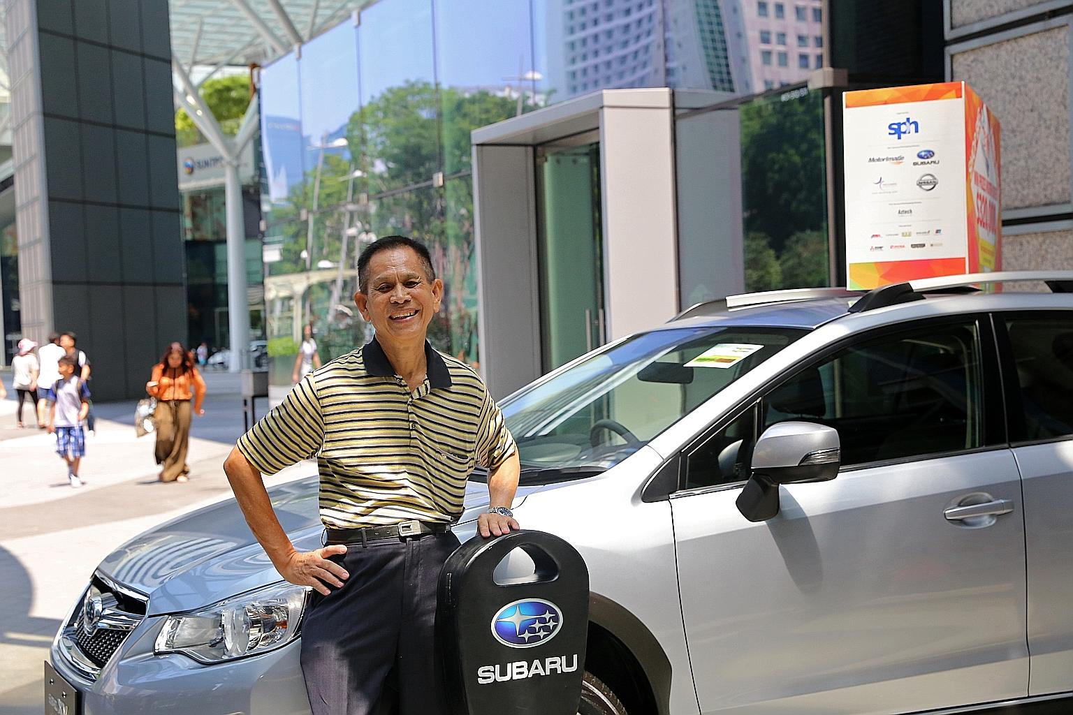 Retiree Tay Say Lian (left) with his new Subaru XV 1.6i-S, which he won at the first draw. In the second draw, SAF regular Goh Yew Boon won a Nissan Sylphy 1.8L.
