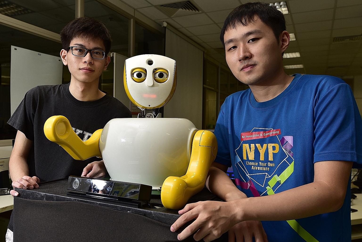 Mr Francis Swee, 20 (left), and Mr Yu Zhigang, 22, with Ruth. The two students from Nanyang Polytechnic make up half of Team Yuuy, which came up with Singapore's newest social robot. Ruth is designed to act like a human being and intended to eventual
