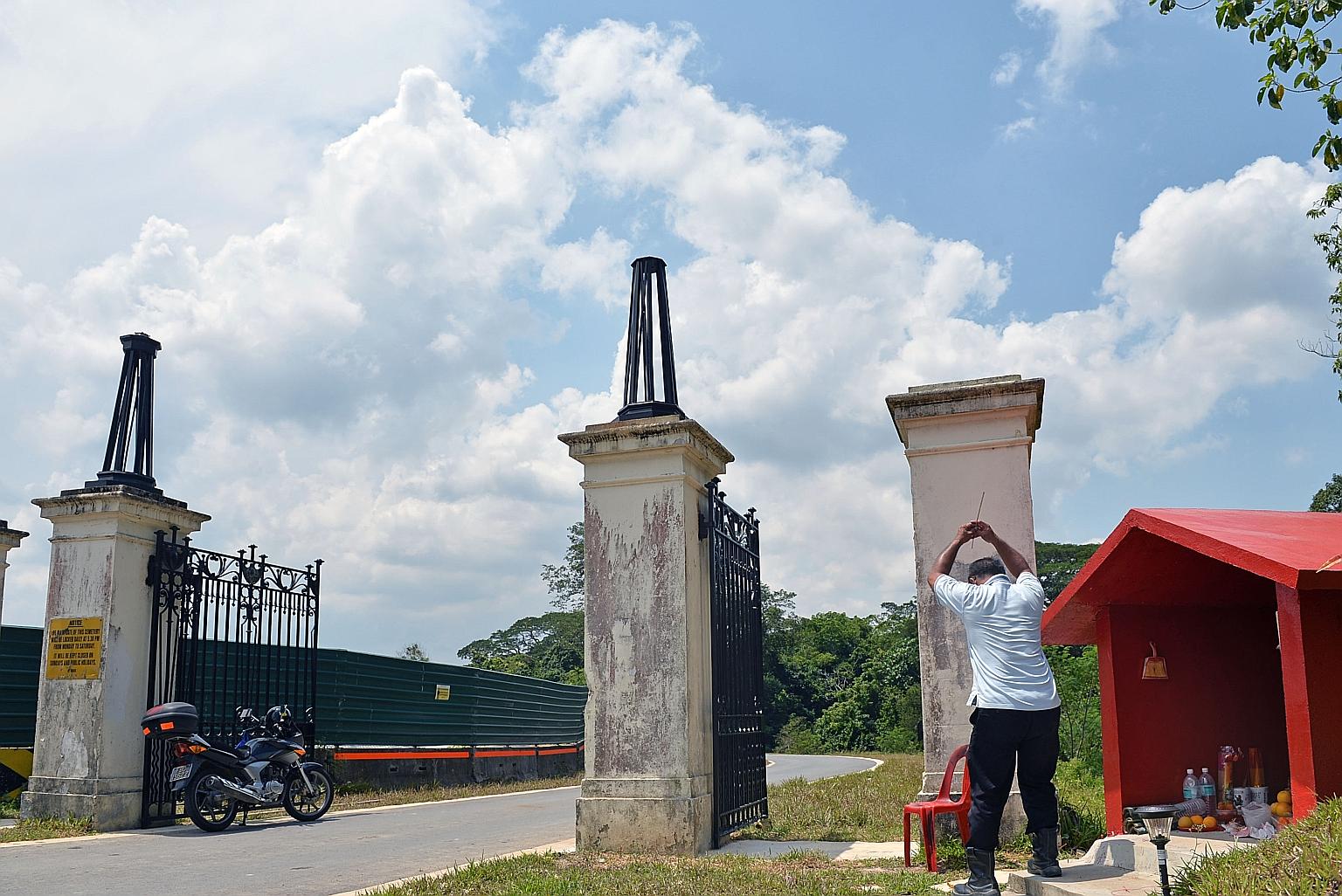 The cleaned and repaired gates were put back on their old posts at their new location - a new access road near Lorong Halwa.