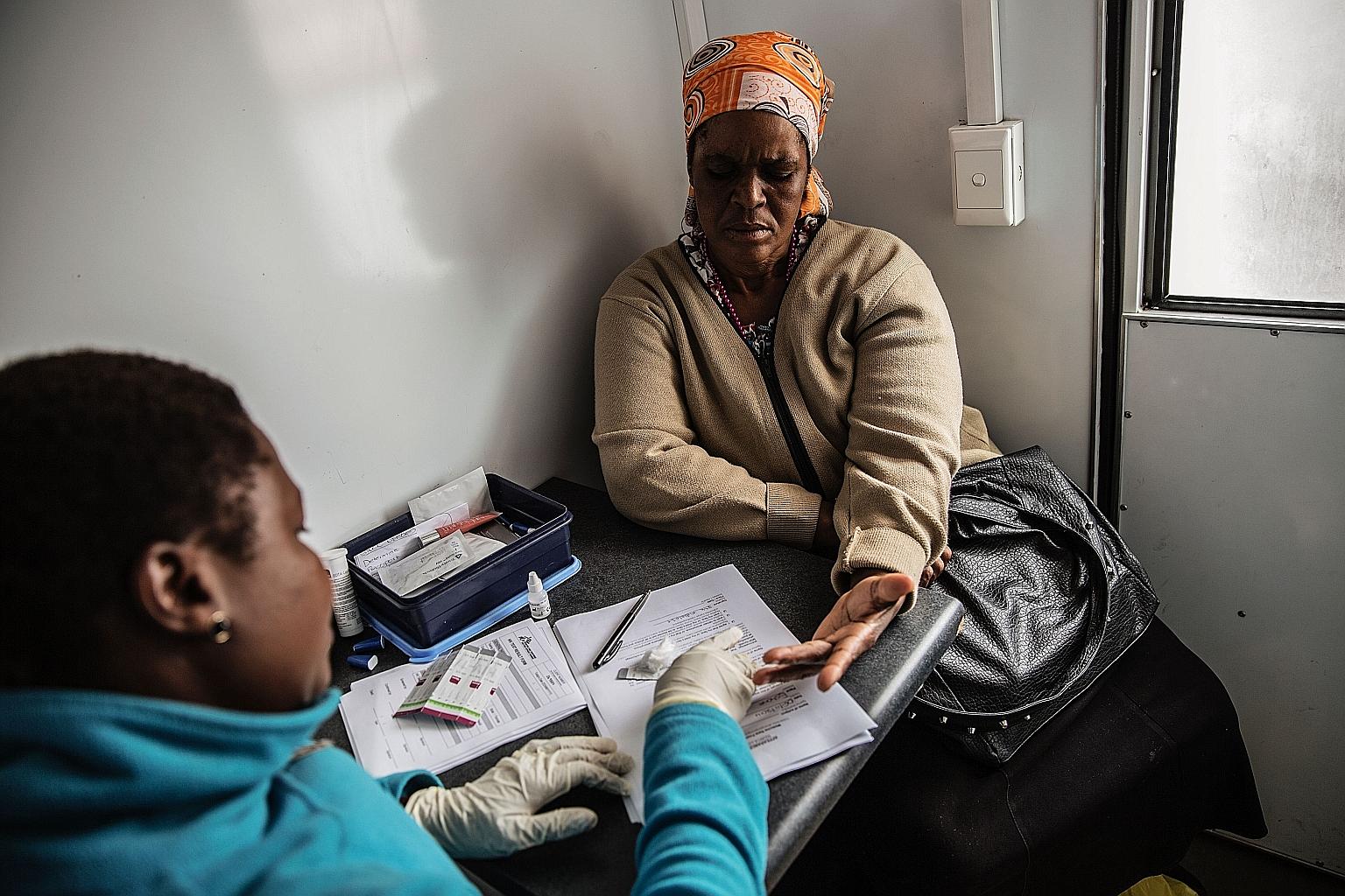 An African woman being tested for HIV. Researchers suspect HIV has spread in Africa because of a mosquito- borne worm that can live in the human lymphatic system for years.