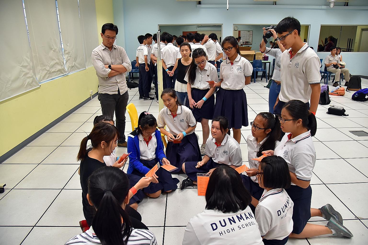 Gateway Entertainment's Mr Wan (far left), who suggested at an SGfuture dialogue that a role-playing game be created to educate students on what to do during a crisis, tried out some game scenarios with Dunman High students last month.