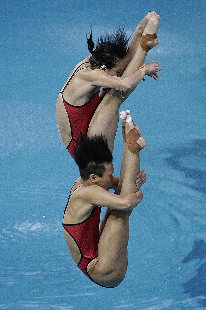 Wu Minxia (top) and Shi Tingmao during the women's synchronised 3m springboard event on Sunday. They led right through the five-round competition and won by a massive margin of 31.77 points.
