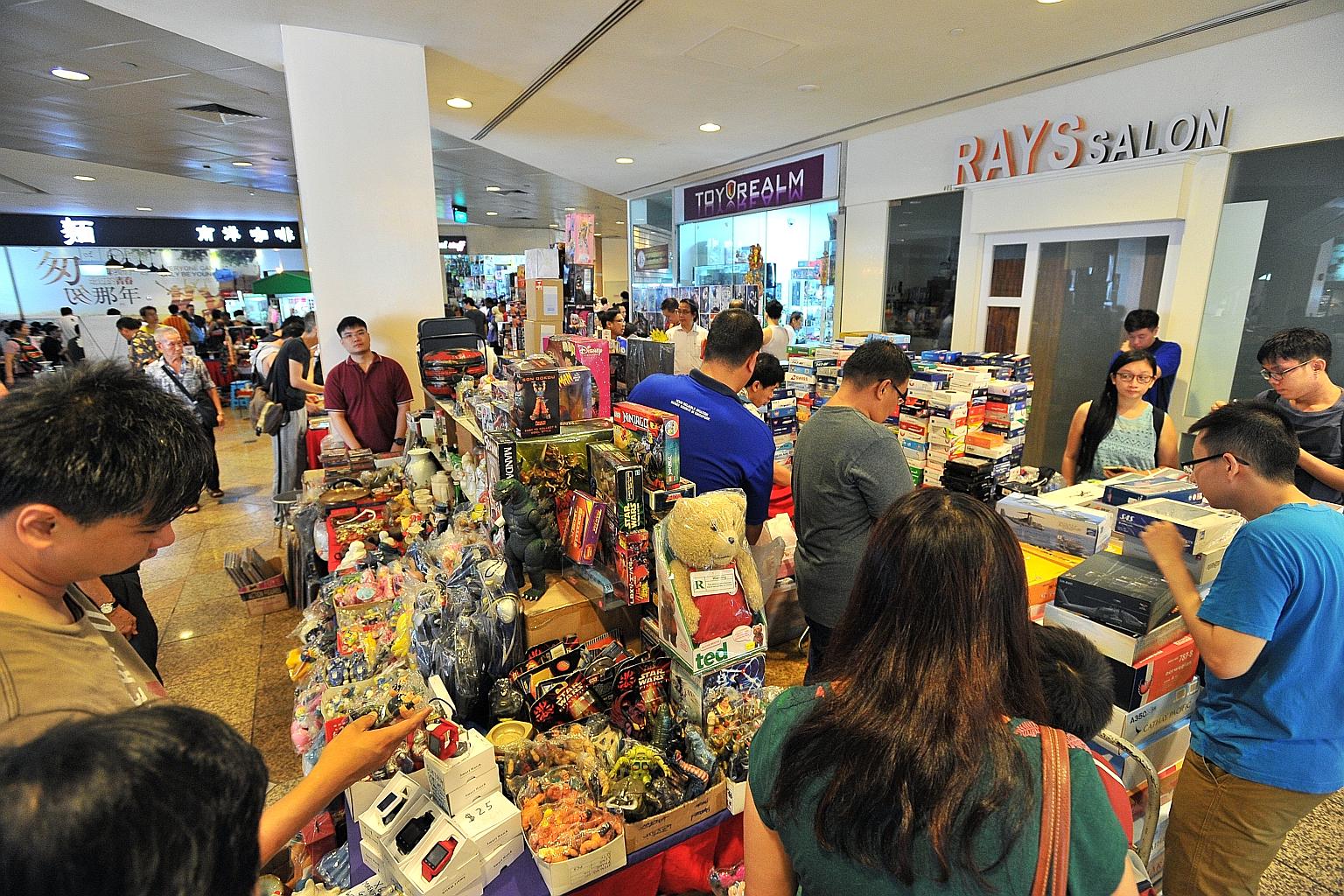 People checking out the toys, collectibles and antiques on sale at the flea market in China Square Central on Sunday. Mr Michael Poh, the organiser of the mall's popular flea market for the past 11 years, says there has been no official word on wheth