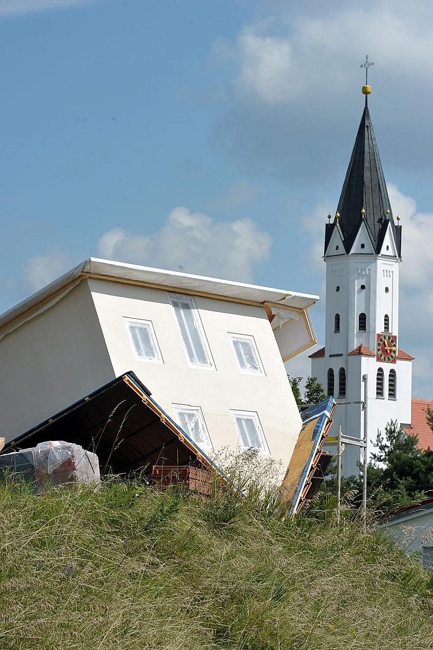A home owner in Stotzard, Germany, placed a 1:2 scale version of his home upside down in his garden to use as a shed. In doing so, he inadvertently created a tourist attraction in the town, about 80km from Munich in the southern state of Bavaria.
