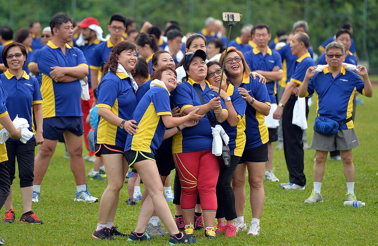 ConfortDelGro's women cabbies snapping a wefie before the morning workout yesterday. About 1,000 of the company's 37,000 taxi drivers got together with their families to exercise at Bukit Gombak Stadium.