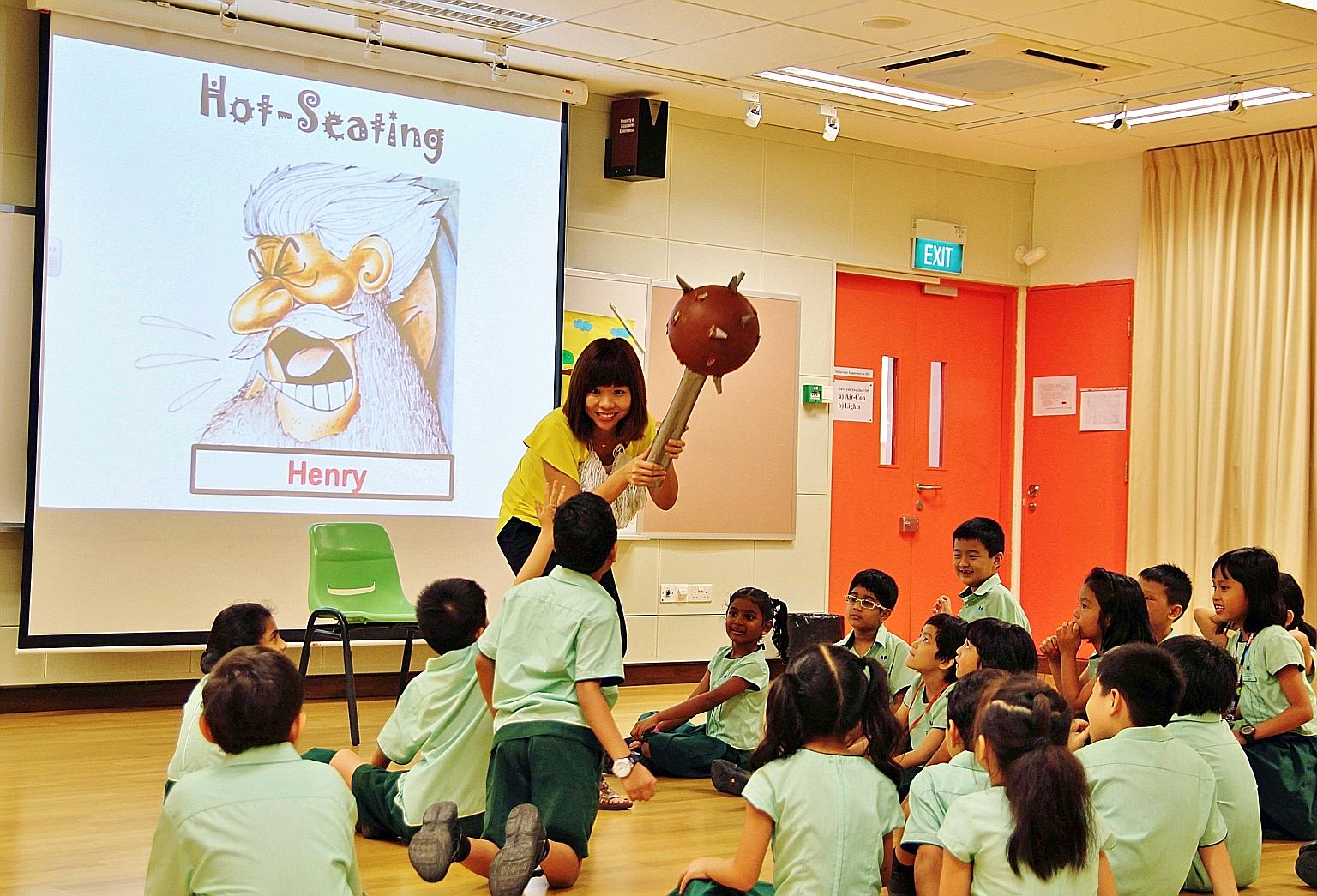 A teacher and her pupils role-playing during a process drama lesson at Farrer Park Primary School.