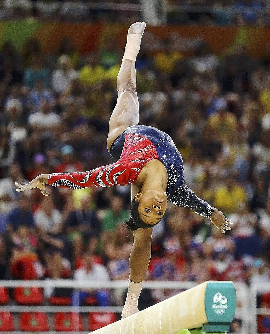 US gymnast Gabby Douglas performing at the 2016 Rio Olympics. In the run-up to the London Games in 2012, it was said that her mother had filed for bankruptcy, brought on partly by the high cost of the gymnast's training.