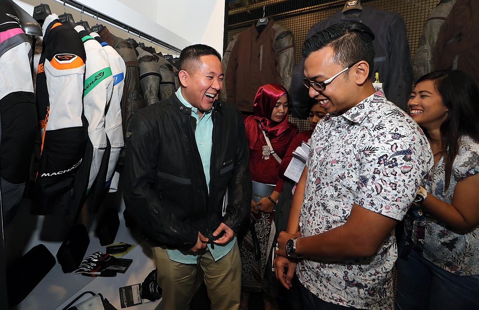 Mr Amin trying on a riding jacket at the Singapore Bike Show yesterday, where the new safety campaign was launched. The Traffic Police say motorcyclists are over- represented in traffic fatalities.