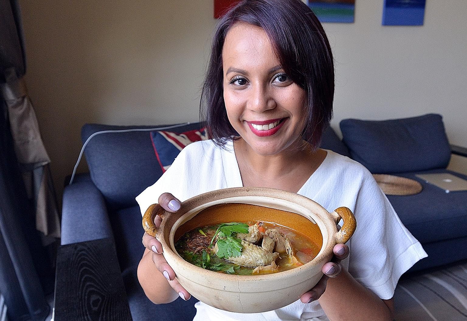 Ms Vasunthara (above) with her comfort food - chicken bone broth cooked with nine spices.