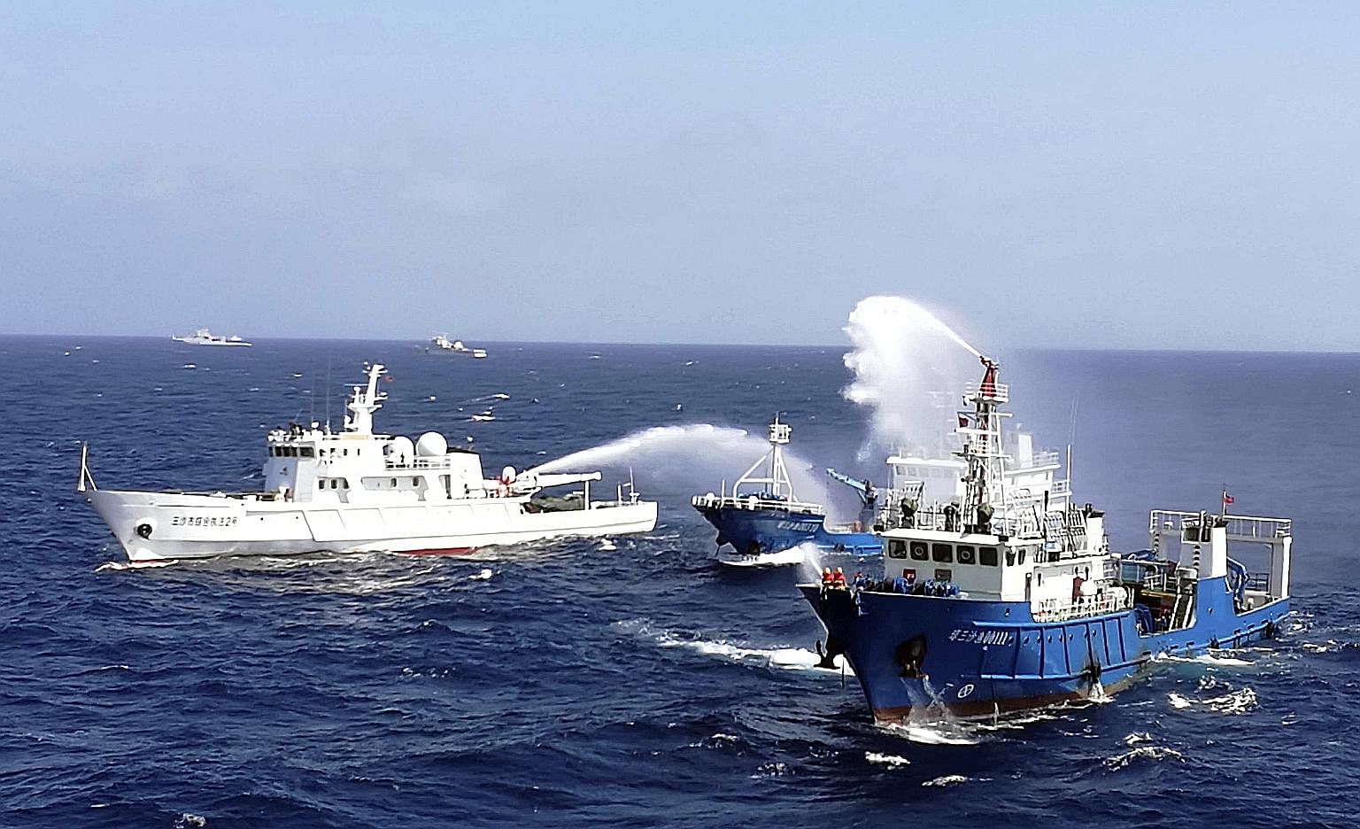 Chinese ships put out a fire on a cargo vessel during a drill in the South China Sea near Hainan province last month. China warned then that it would respond decisively to provocations in the South China Sea, as it faced mounting pressure to accept a
