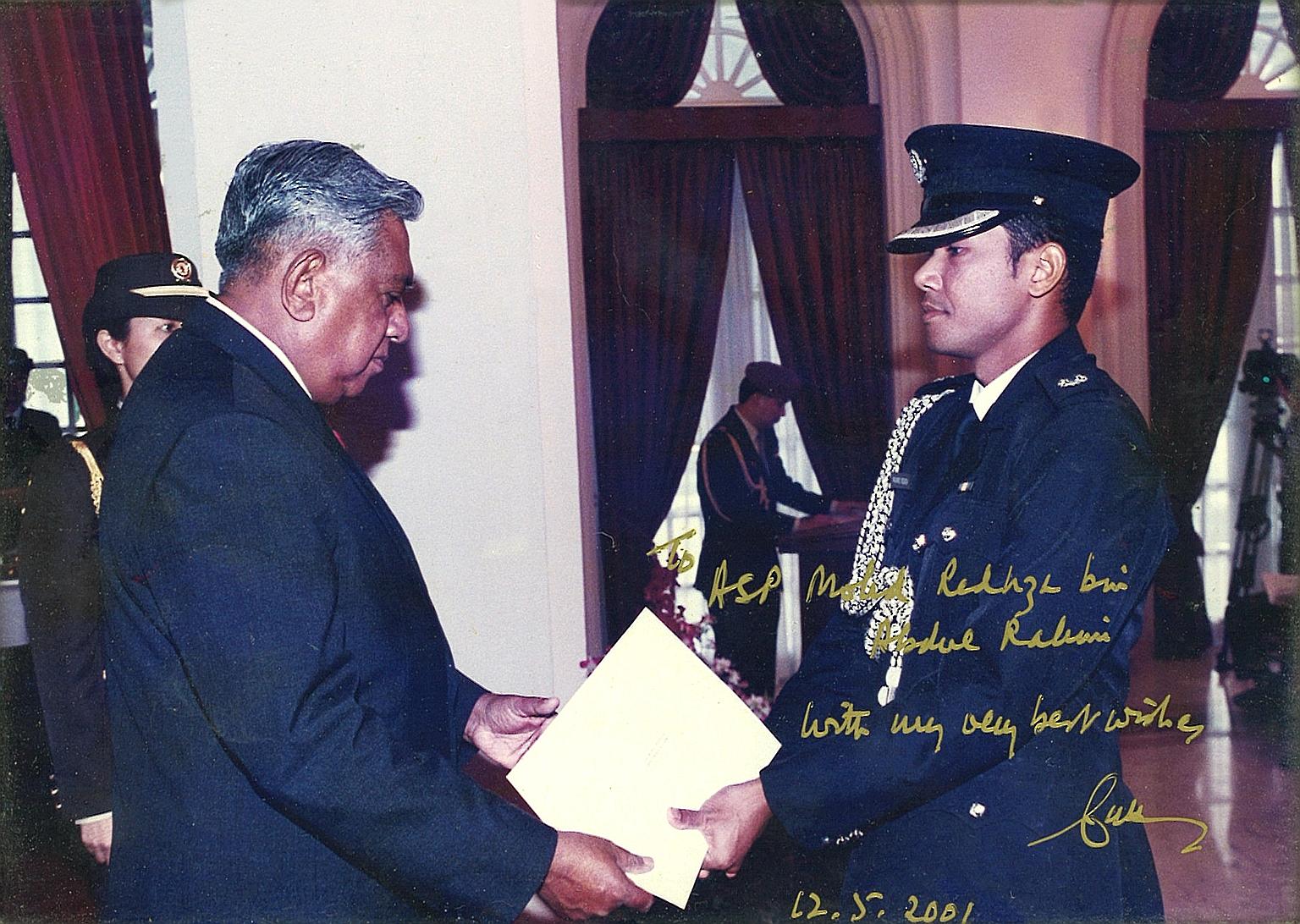 Mr Nathan giving Mr Redhza his appointment certificate when the latter was made an honorary aide-de-camp in 2001 after his stint as full-time ADC. The President later wrote a message on the photo as a keepsake for Mr Redhza.