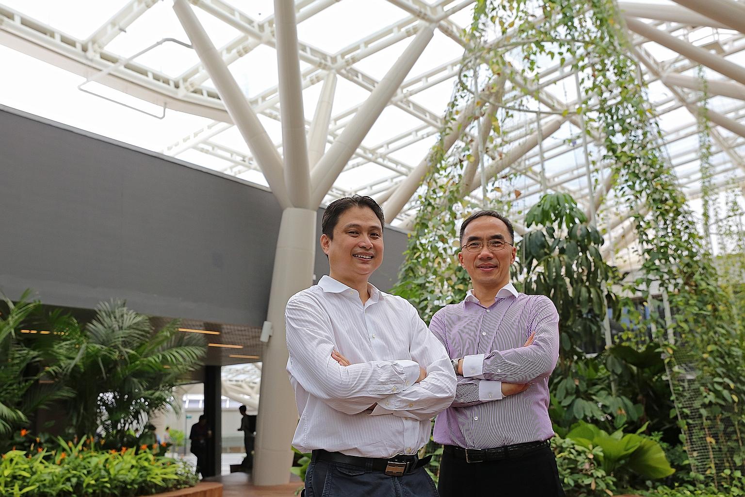 Dr Goh Chin Foo (far left) and Adjunct Associate Professor Matthew Tan at the atrium in NTU. The coating was applied to the atrium's roof, and has helped to reduce the temperature by some 8 deg C.