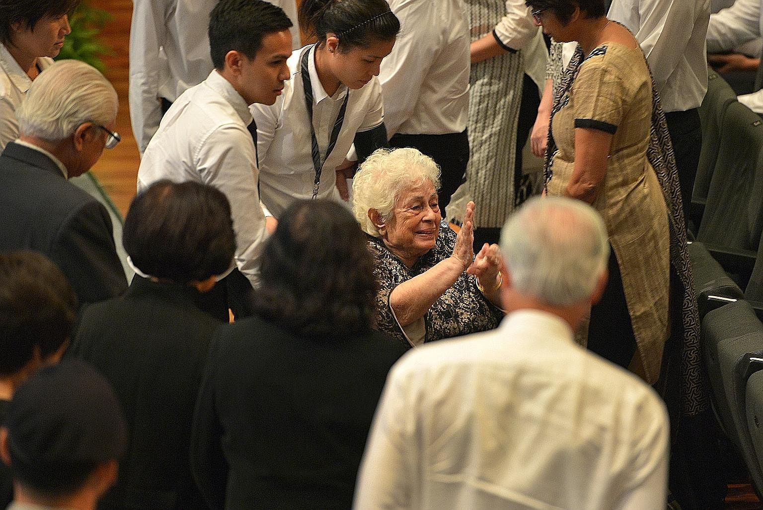 Mrs Nathan waving to attendees as she left the University Cultural Centre auditorium yesterday. The 87-year-old has been hailed as the anchor for Mr Nathan. As PM Lee put it in the most poignant line in his eulogy for Mr Nathan: "The central and brig