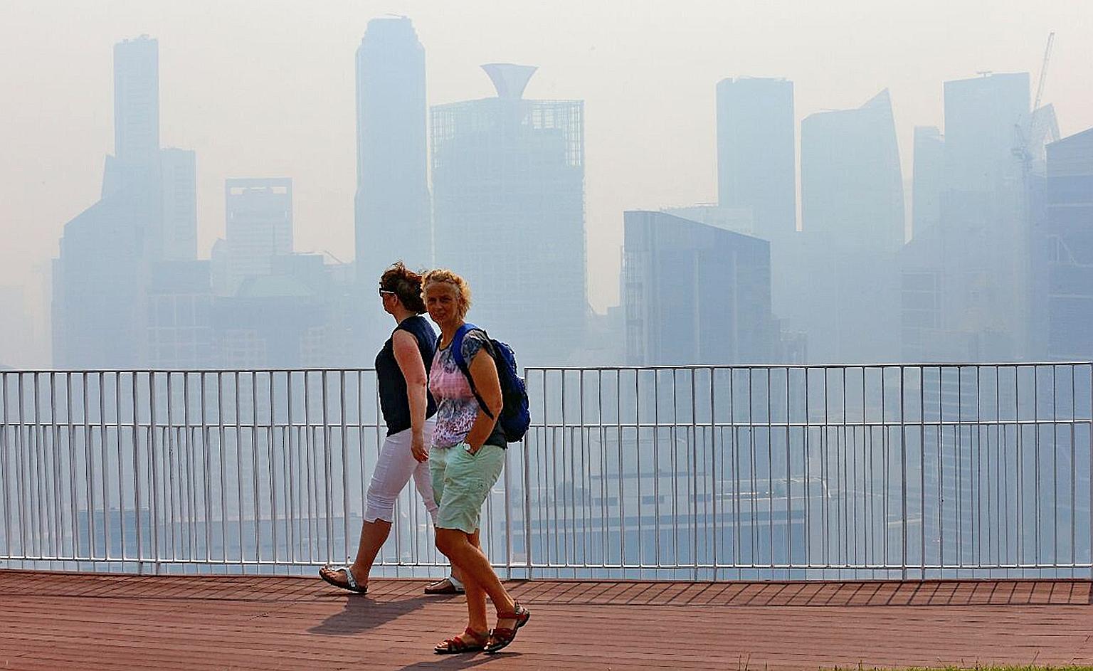The view from the skybridge at Pinnacle @ Duxton at 10.45am yesterday. Buildings in the distance were barely visible as winds carried the haze from Sumatra to Singapore. Similar unhealthy conditions are likely to persist today, said the NEA.