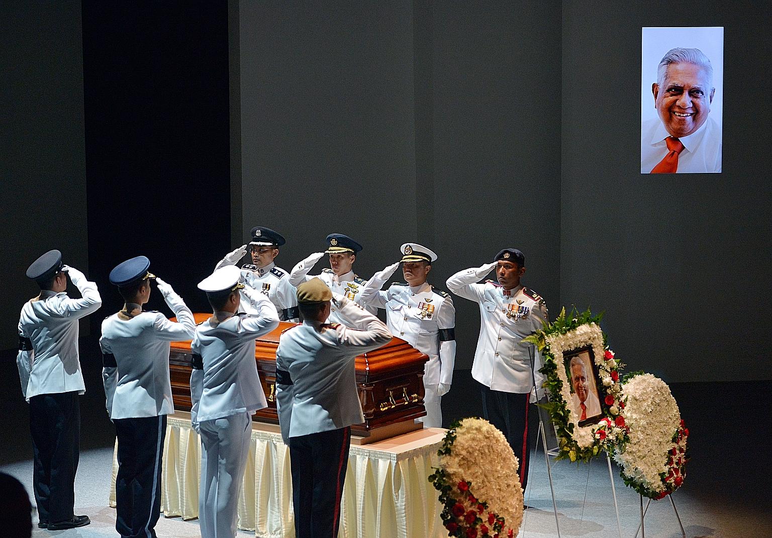 Final salute for Mr Nathan from the coffin bearer party from the armed forces and police during the state funeral service at the University Cultural Centre yesterday.