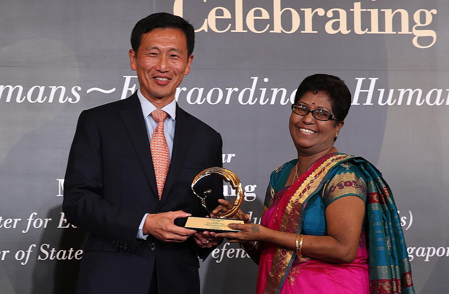 Mr Ong Ye Kung, Acting Minister for Education (Higher Education and Skills), presenting Madam Gurusamy Intrany with a Silent Heroes award last Saturday. Madam Intrany counsels couples on the verge of divorce, donates to old folks' homes and gives mon