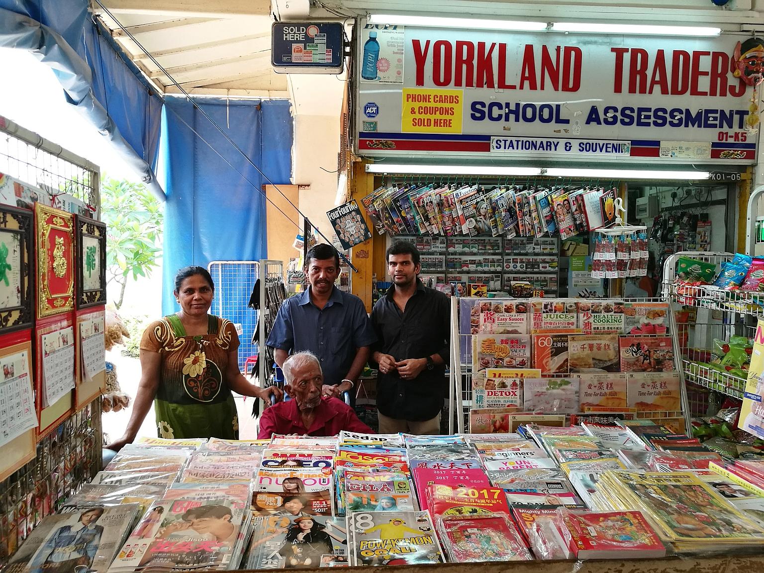 Yorkland Traders owner K. Mohan Raj (centre, in blue) with his father R. Krishnavenu (seated) and shop assistants, Madam R. Pommi and Mr R. Selvaraj. The magazine and sundry shop in Aljunied is among HDB businesses that stand to benefit from the late