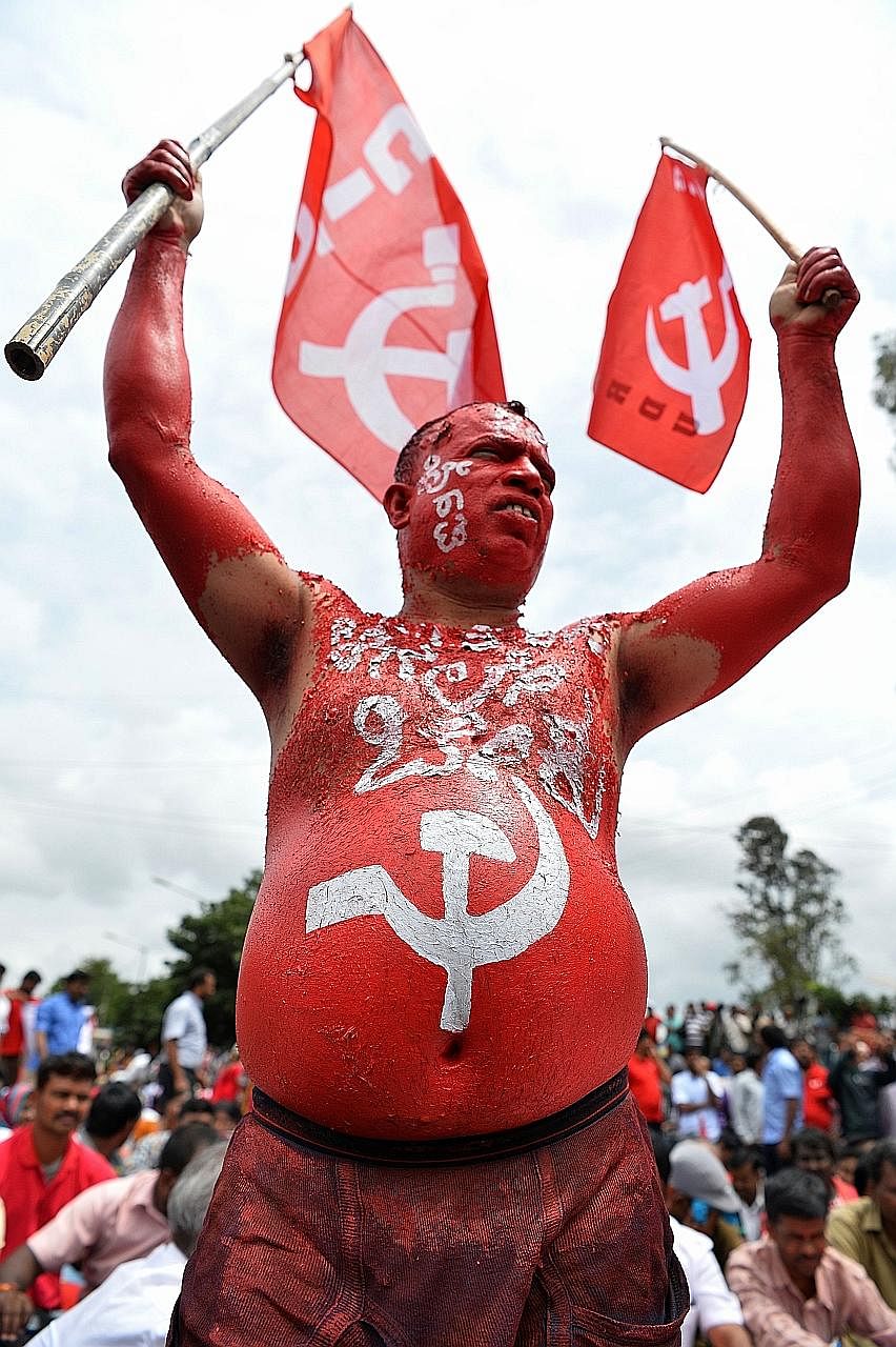 A Centre of Indian Trade Unions activist during a protest in Bangalore yesterday as part of nationwide stoppages.