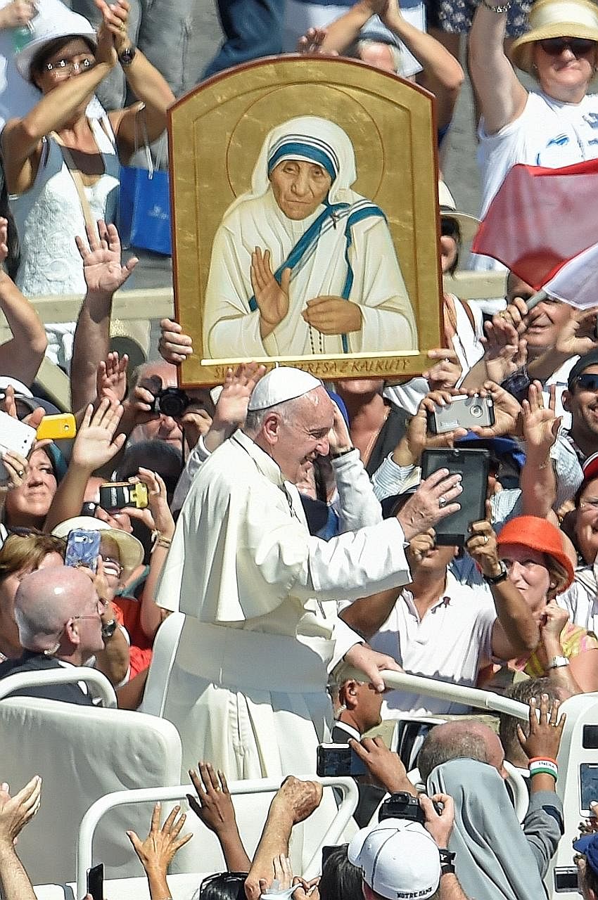 Pope Francis with pilgrims at the Vatican yesterday. The Nobel peace laureate was canonised yesterday, just 19 years after her death.