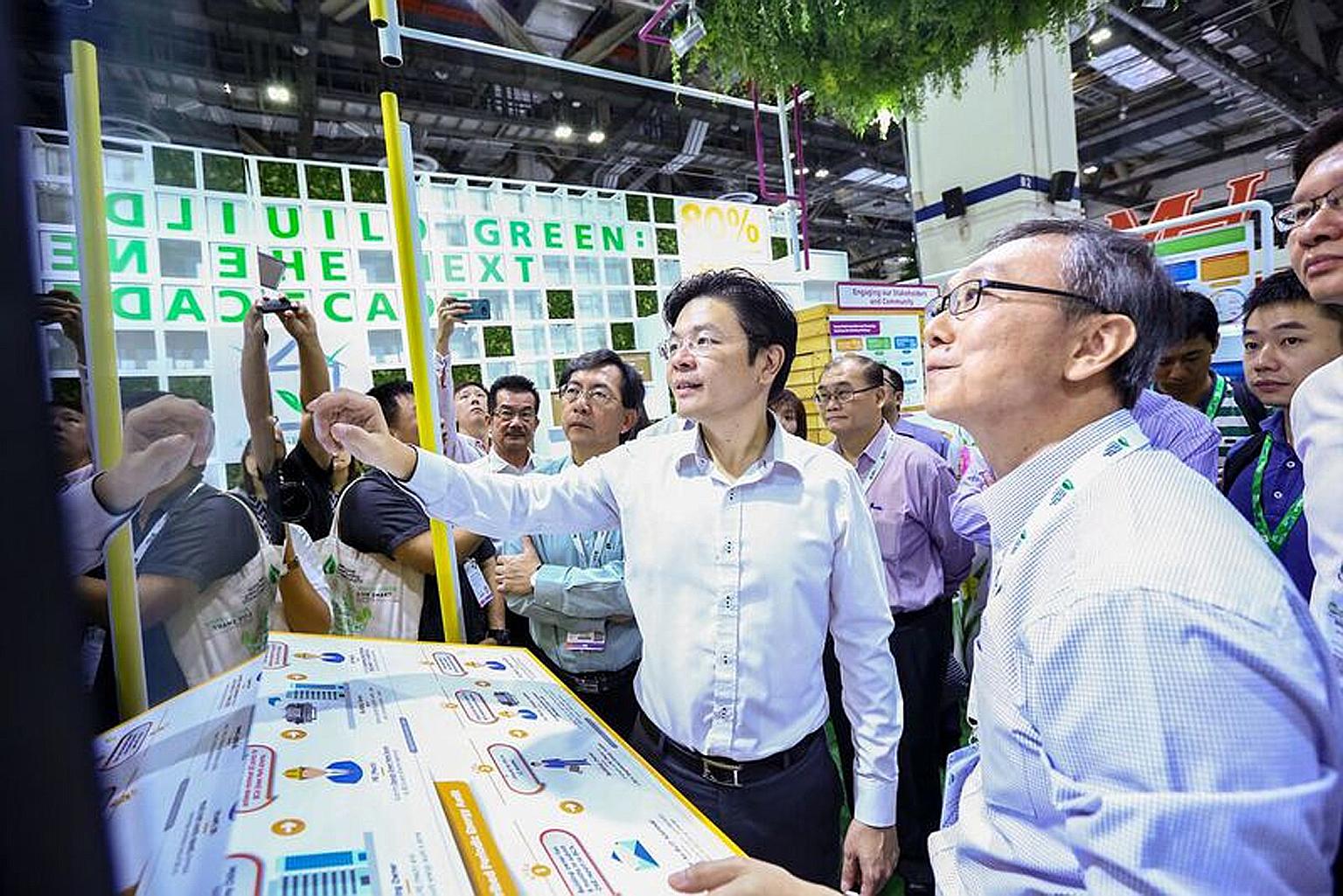 Mr Wong, flanked by Mr Francis Tay (at right), senior manager of the Green Mark Department at the BCA, and BCA chief executive John Keung, at Build Eco Xpo Asia yesterday. Residential buildings here will have to use smart technologies to be Green Mar