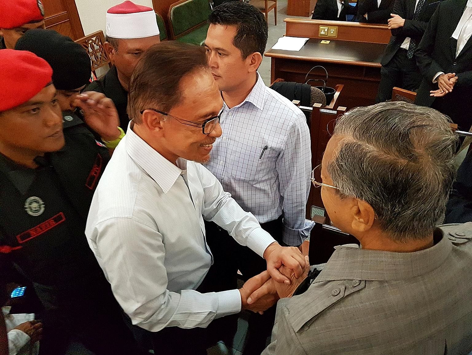 Malaysia's former prime minister, Dr Mahathir (right), shaking hands with Anwar at the Kuala Lumpur High Court on Monday - a gesture that led many to wonder if this could be the start of a new chapter in the country's politics.
