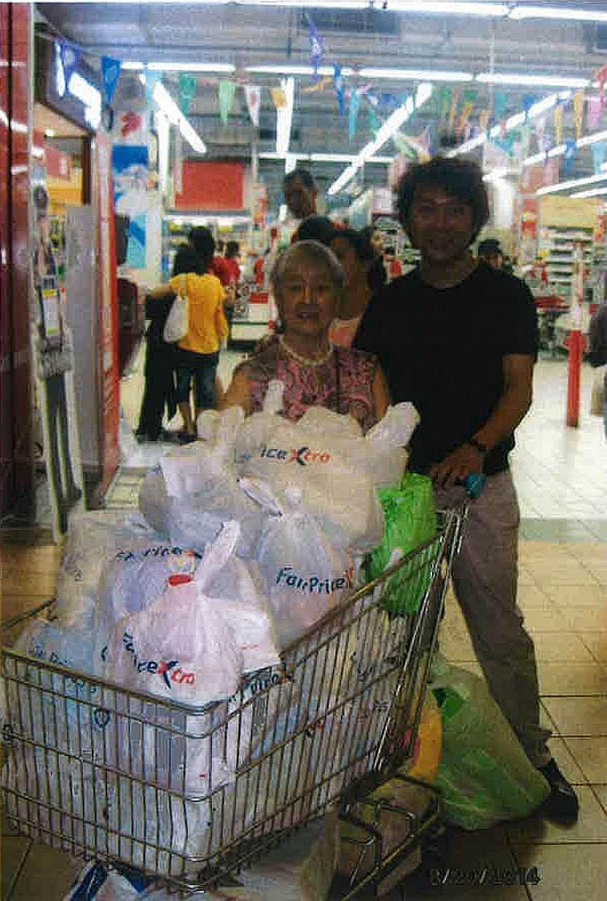 Among the photographs submitted by Yang's lawyer to make the point that the former tour guide took care of Madam Chung and took her to places where she wanted to go, is one of the two of them with a trolley of groceries at a supermarket.