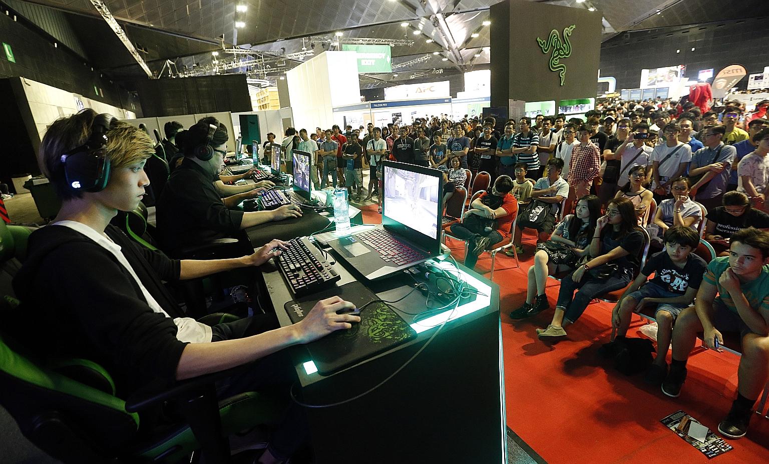 Gamers battling it out at the inaugural Singapore E- Sports League, the highlight at Comex. More than 30 teams competed in four tournaments over four days for more than $20,000 worth of gaming products.
