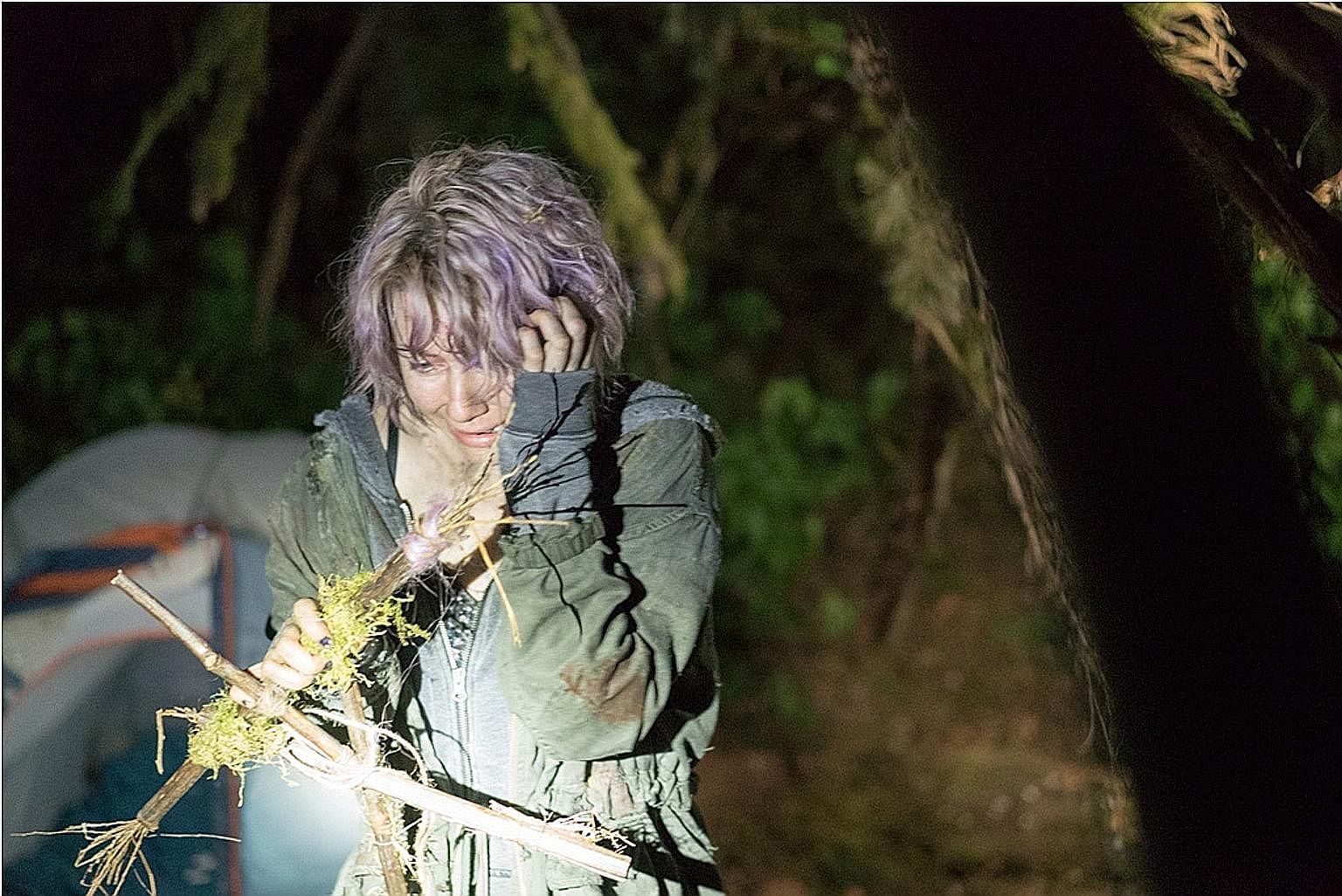 (Above) Valorie Curry in the Blair Witch reboot, which is based on the invented history of an 18th-century woman cast out and left to die in the Maryland woods.