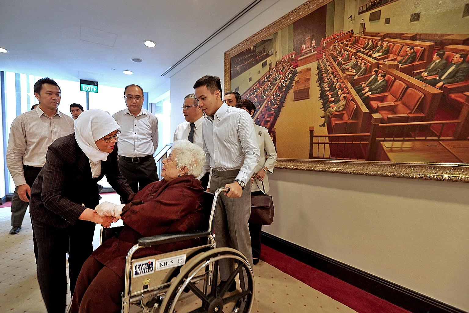 Speaker of the House Halimah Yacob talking to Madam Urmila Nandey, former president S R Nathan's widow, at Parliament House yesterday. Behind them are (from left) Mr Nathan's former special assistants Henry Goh and Desmond Yong, son-in-law Cheong Gay