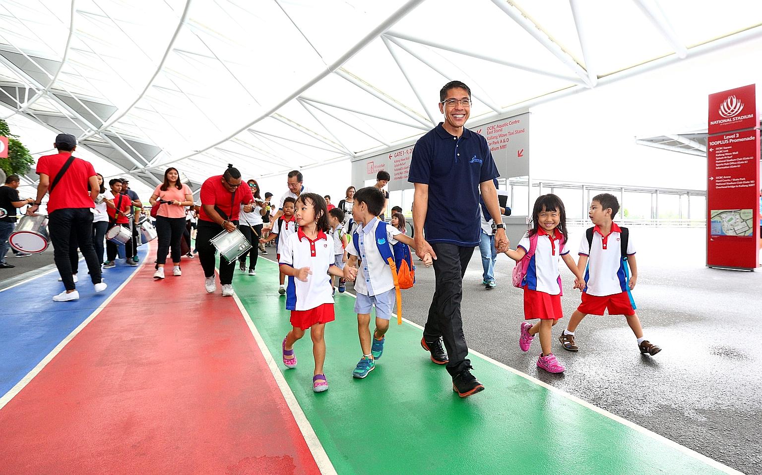 South East District Mayor Mohamad Maliki Osman leading the launch of the FairPrice Walk for Rice. Yesterday, recipients of the programme from the Bedok Radiance Senior Activity Centre became the first beneficiaries to earn rice for other underprivile