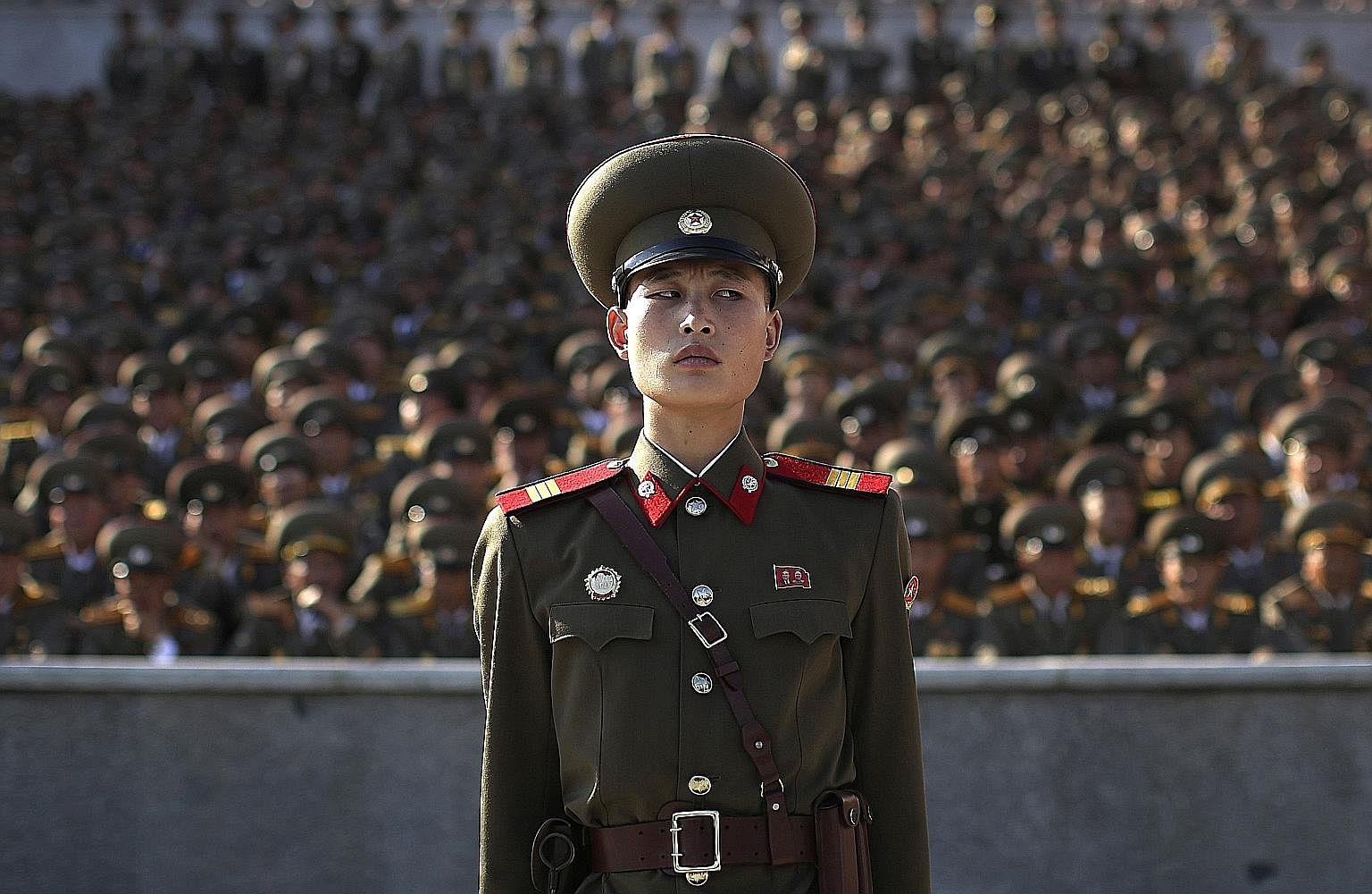 A soldier at a parade in Pyongyang, North Korea, on Oct 10 last year to mark the 70th anniversary of the country's ruling party. A photographer making an "official" group picture, using an 8x10 camera, of the "educated youth" of the Youth Shock Briga