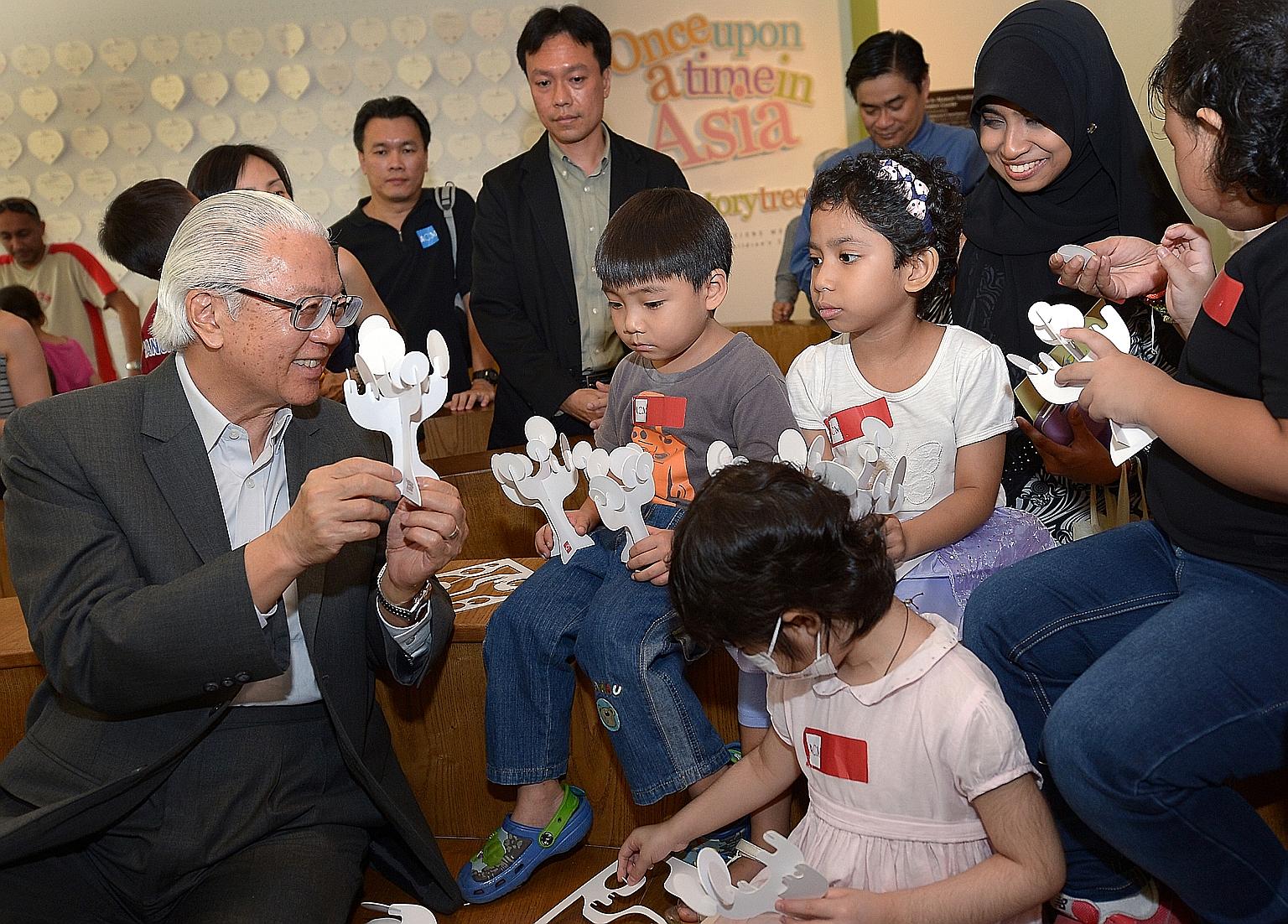 President Tony Tan Keng Yam interacting with children at a 2014 exhibition. Every Singaporean has to be able to identify with the president, said the Government.