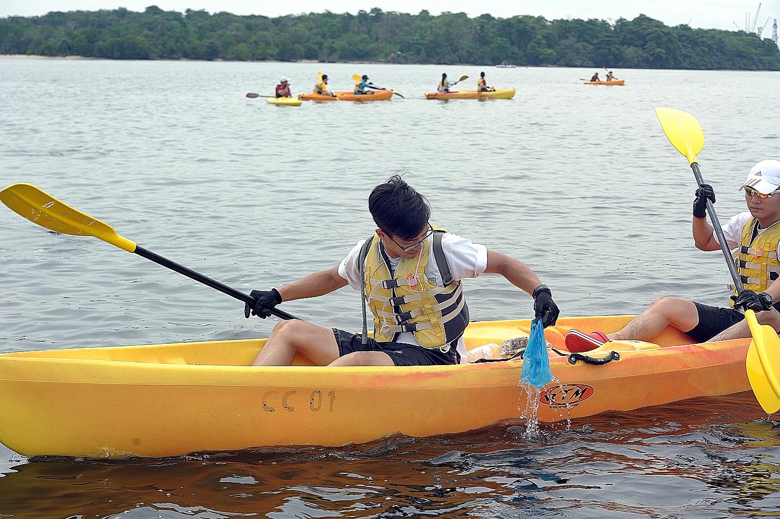 Volunteers, including secondary school students, on kayaks doing their part to clear garbage from Singapore's waters yesterday as part of International Coastal Cleanup Day. During a three-hour trip from Sembawang Beach to Seletar Island, the group co