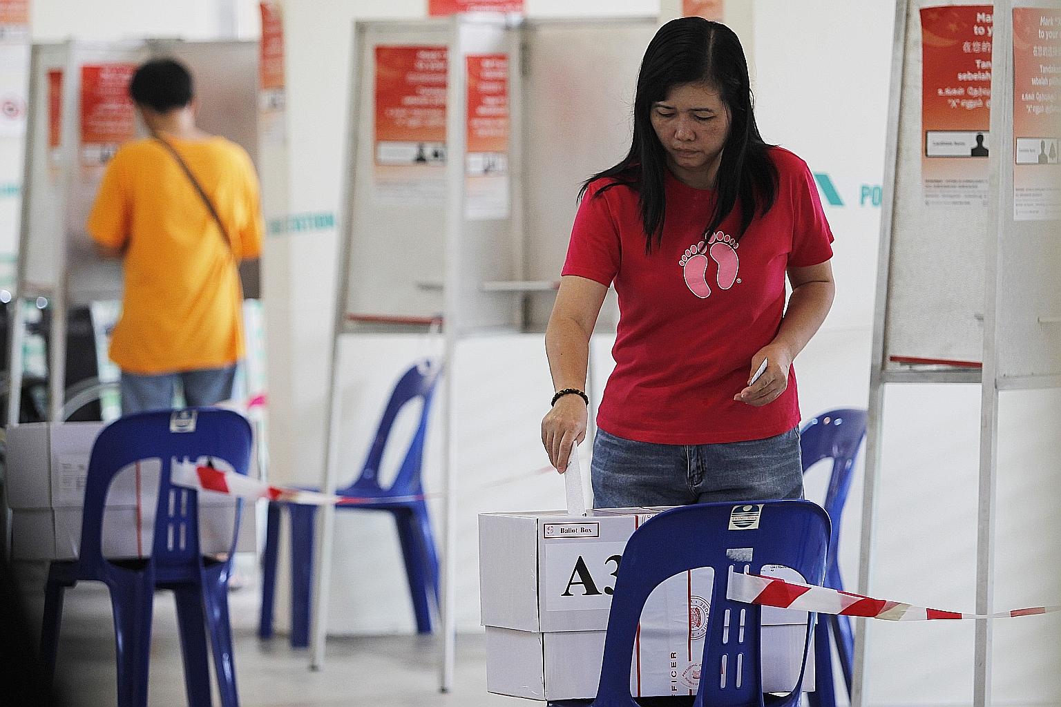 A voter at a polling station during the 2011 presidential election. Mr Shanmugam notes that while there is no ideal way of choosing the best person for the role of president, the changes to the eligibility criteria could be seen as markers for findin
