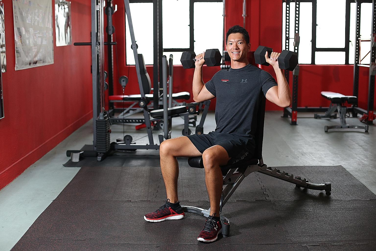 Mr Chung doing shoulder exercises with free weights.