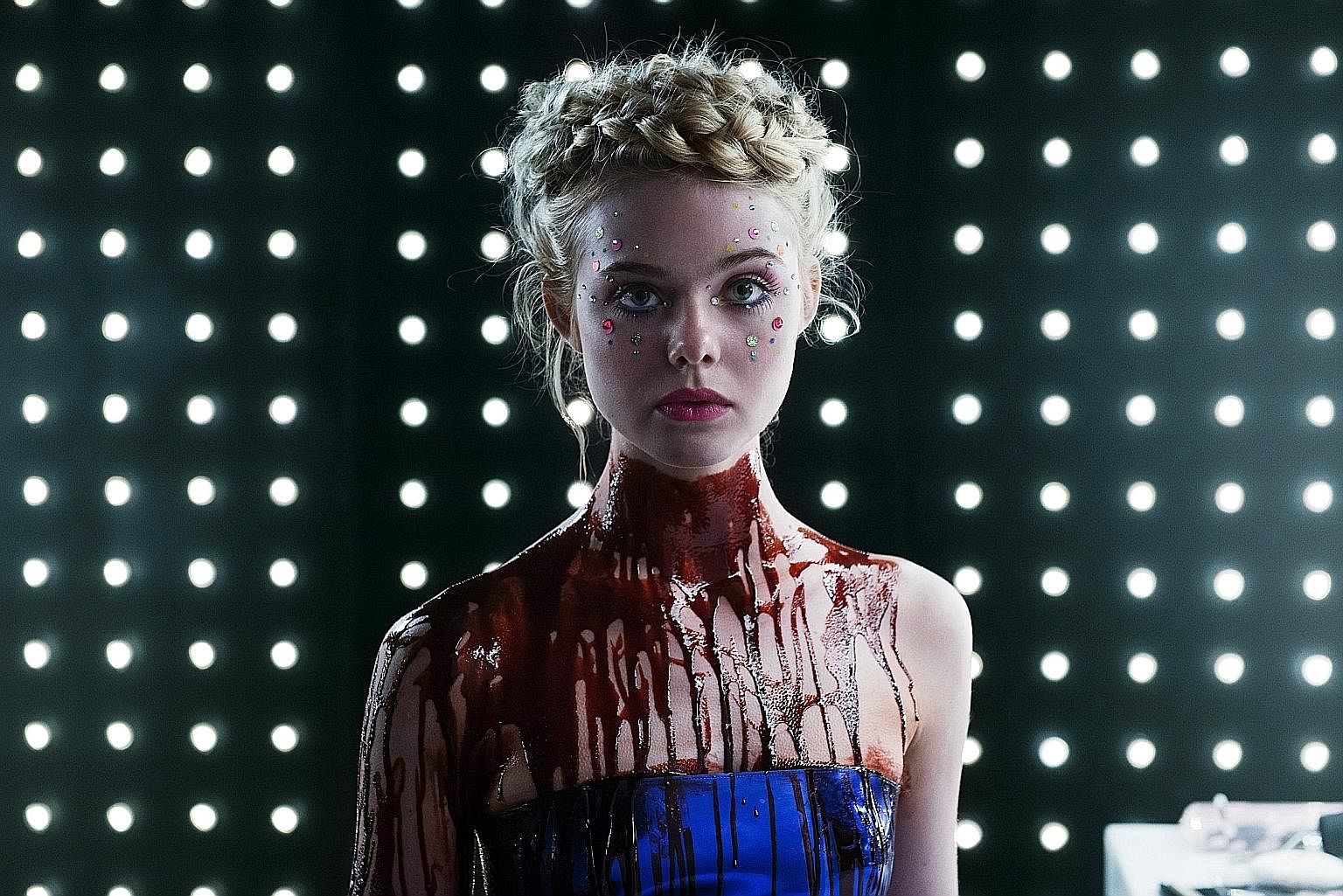 Elle Fanning (left) plays a model with otherworldly beauty in The Neon Demon.