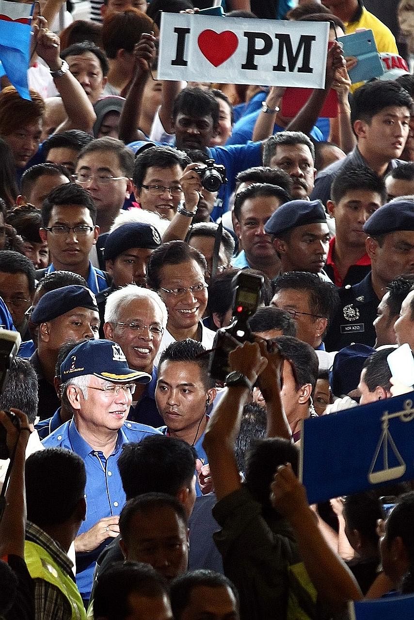 Malaysian Prime Minister Najib Razak (wearing a cap) at a rally for the 2013 general election. Although Mr Najib does not have to call for a national election until mid-2018, the signs point to an election in 2017, possibly in the later half.